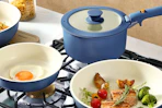Lifestyle image of the Carote Cookware Set in the color Navy Blue