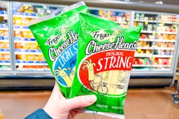 hand holding packs of frigo cheese
