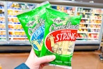 hand holding packs of frigo cheese