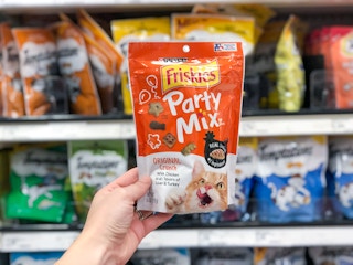 Friskies party mix being held in aisle