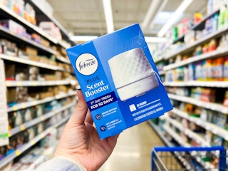 hand holding a box of the Febreze oil diffuser in a Walmart aisle