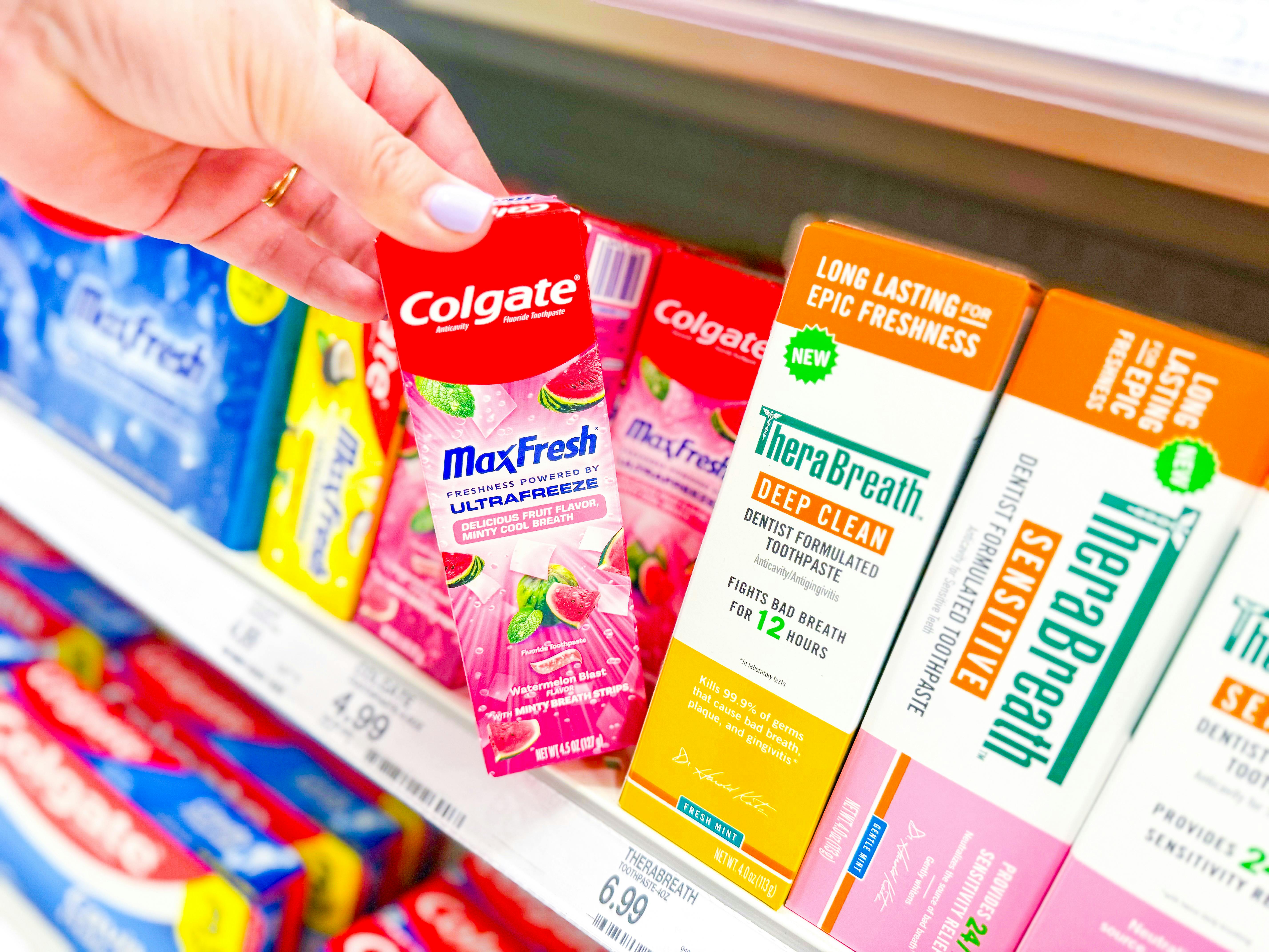 grabbing a colgate max fresh toothpaste off a target shelf