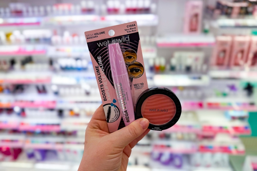 person holding wet n wild mascara and blush