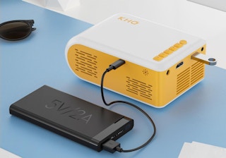a yellow and white projector plugged into a device 