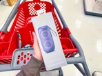 hand holding heyday bluetooth speaker over target cart