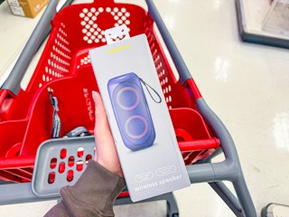 hand holding heyday bluetooth speaker over target cart