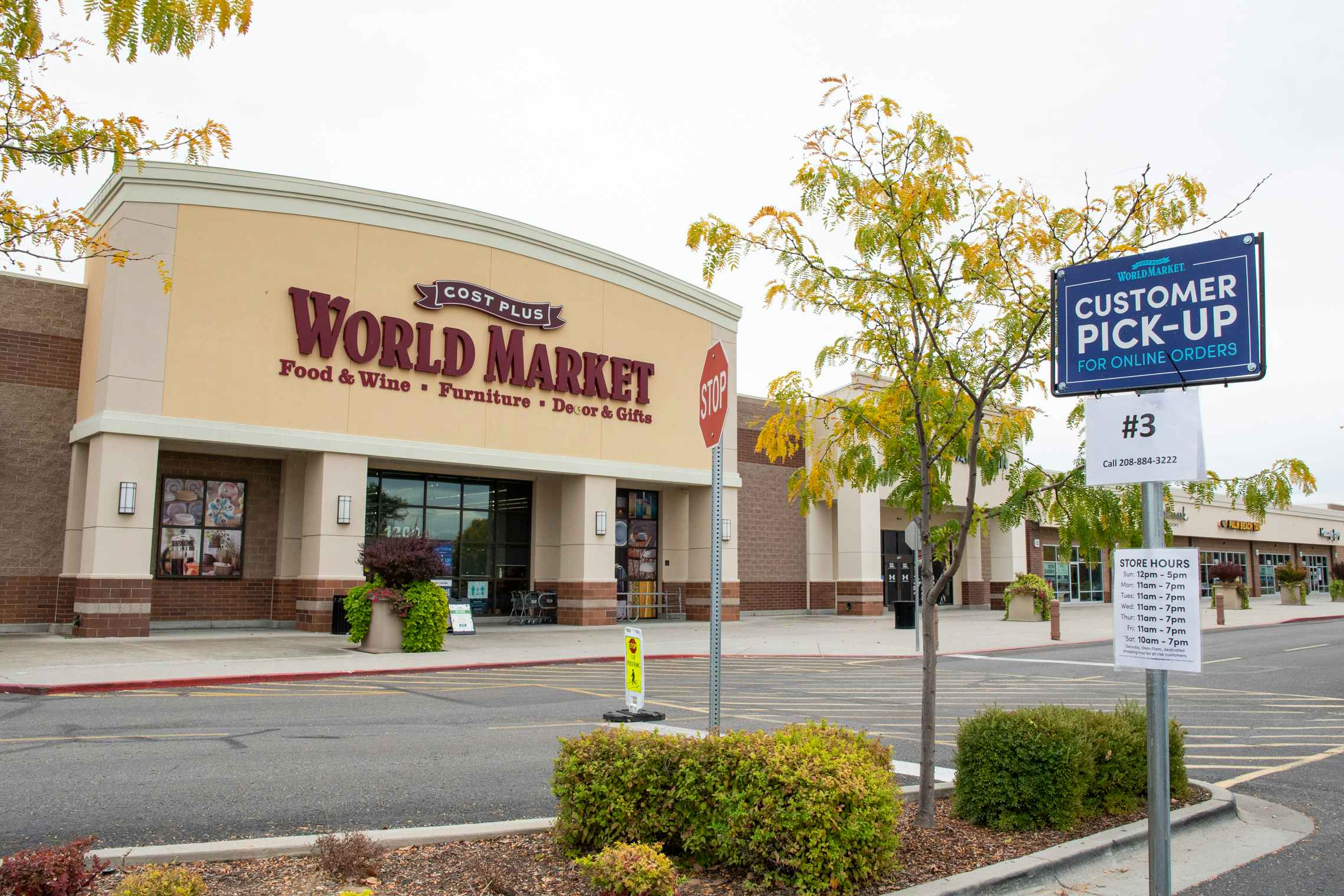 World Market store front with customer curbside pickup sign