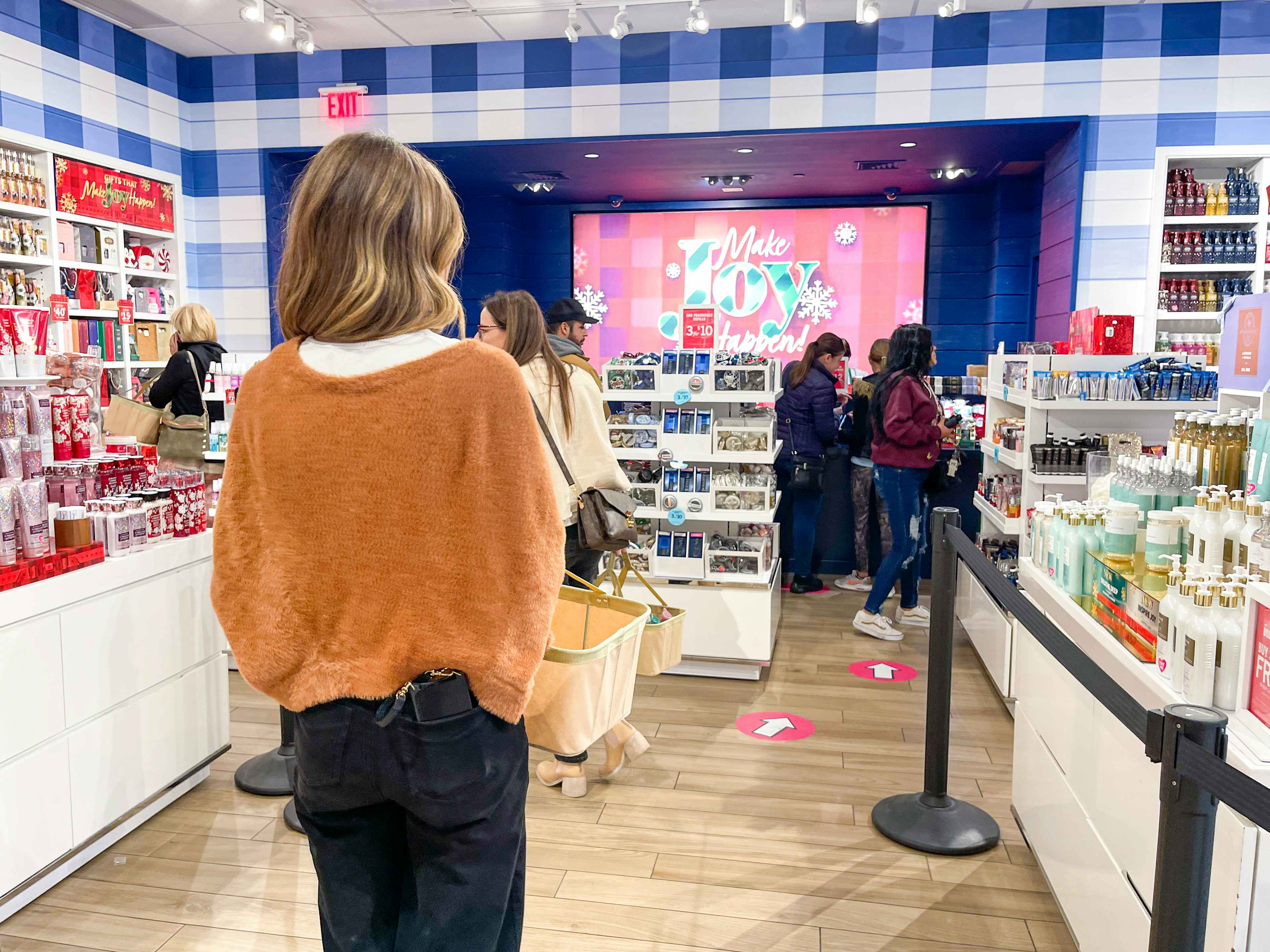 A woman standing in line at Bath and body Works
