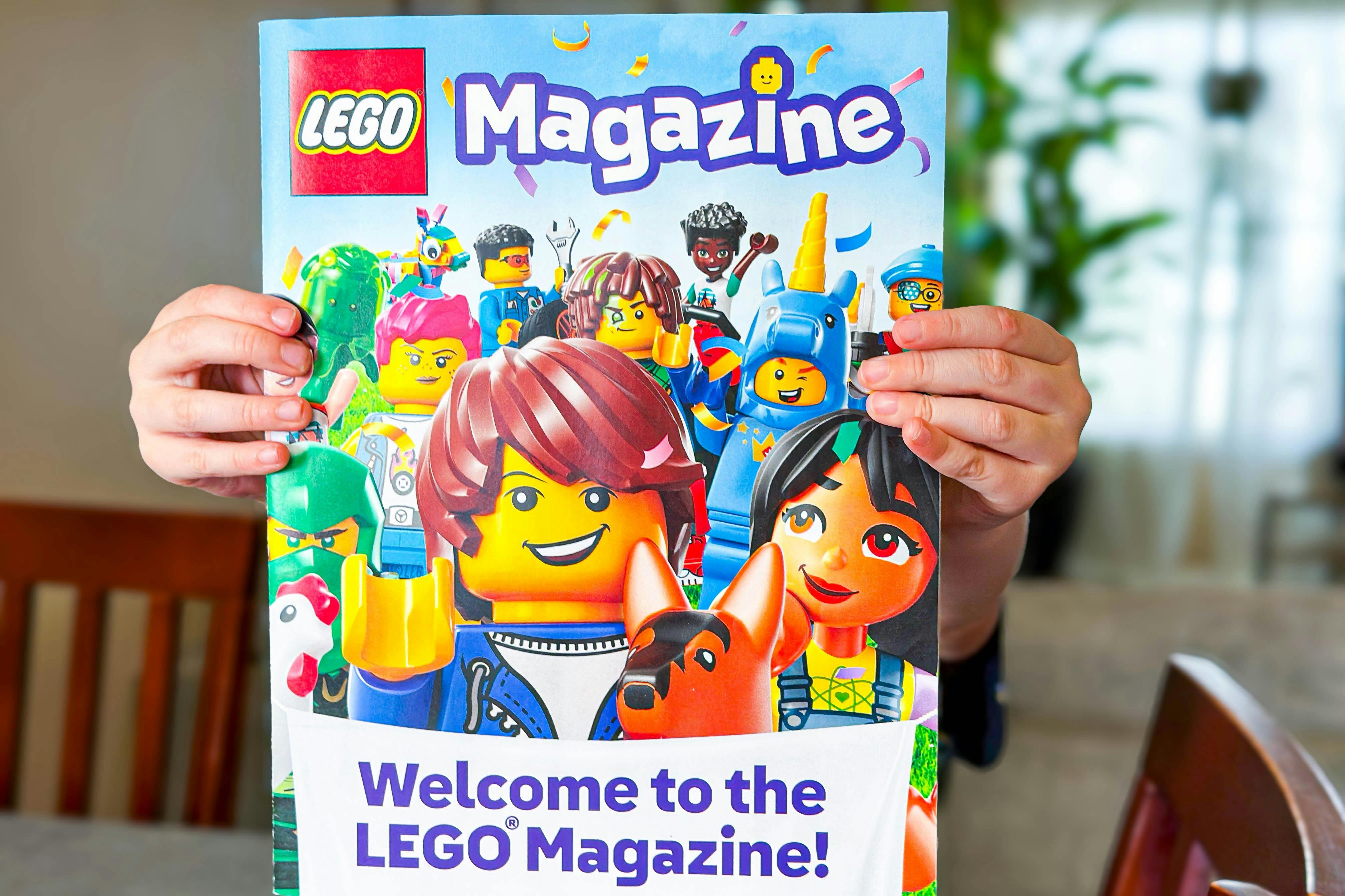 lego magazine being held out by a kid 
