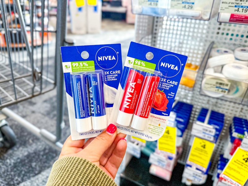 person holding 2 nivea lip balm 2-packs