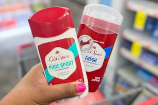 hand holding two Old Spice deodorants