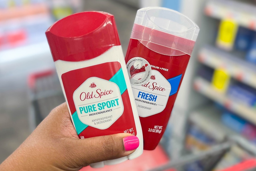 hand holding two Old Spice deodorants