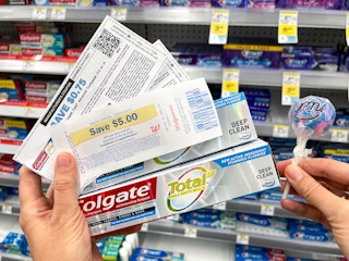 a person holding colgate toothpaste at walgreens 