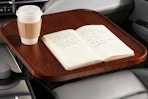 car desk holding notebook and coffee cup