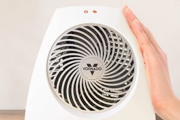 Lifestyle image of the Vornado Indoor Heater with hand placed on the side