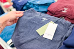 hand grabbing a goodfellow & co men's t-shirt off a target shelf