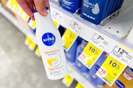 person holding a bottle of nivea lotion