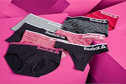 Lifestyle image of Reebok Women's Underwear Seamless Hipster Panties with pink geometric background