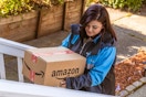 an amazon delivery driver walking up stair with a package 