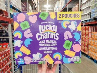 hand holding a box of lucky charms marshmallows