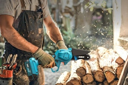 a man using a mini chainsaw