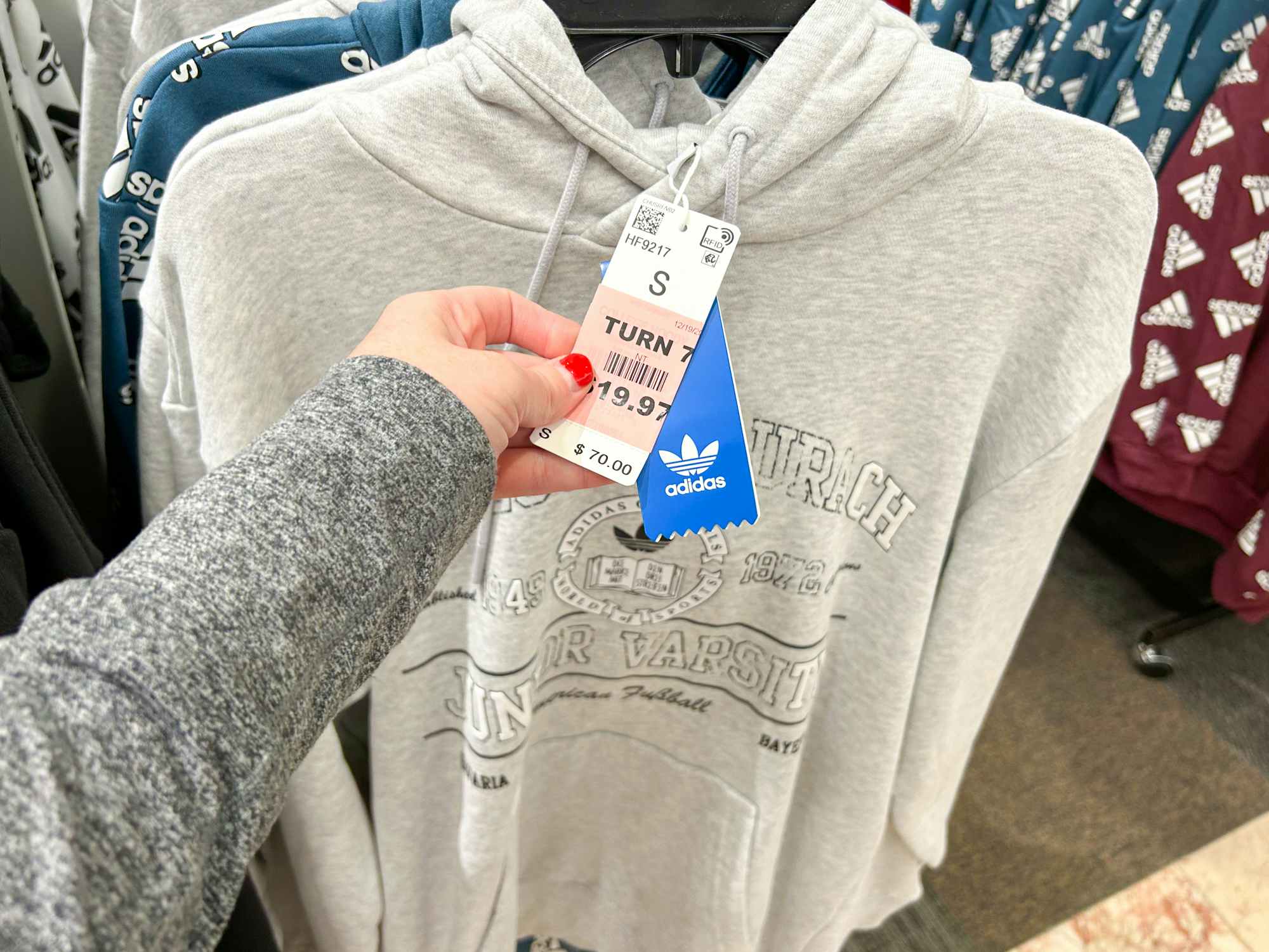 An Adidas hoodie with a price tag for $19.97