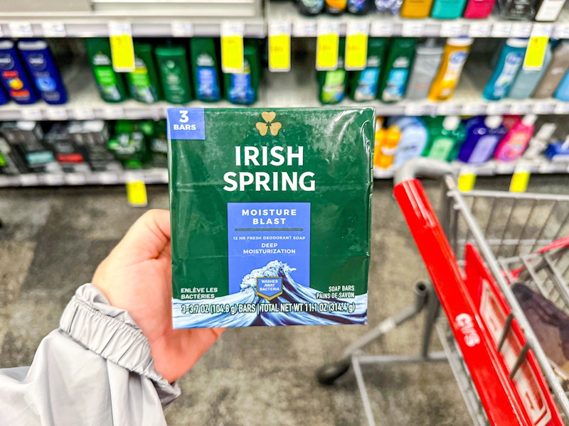 person holding irish spring bar soap by a cvs cart