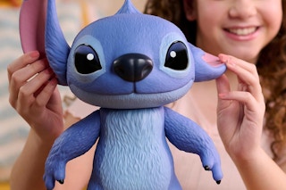 a girl playing with a stitch vinyl figure