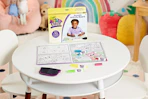 lifestyle image of a crayola color and erase board on a table in a kids playroom