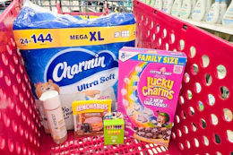 charmin toilet paper, lucky charms cereal, mondo llama crayons, lunchables, and honest baby wash in a cart