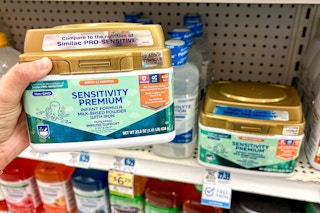 hand holding a container of Rite Aid Sensitivity Premium infant formula