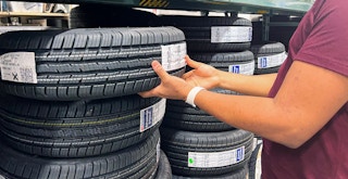 Someone shopping for tires in a store