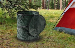a collapsible trash can outside of a tent