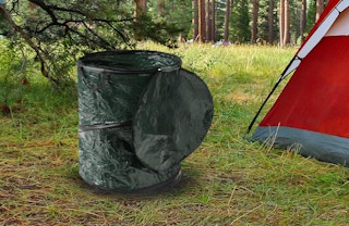 a collapsible trash can outside of a tent