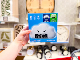 hand holding a kids wake up light alarm clock at target