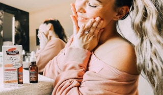 A woman smiling by her cocoa butter