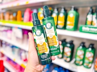 hand holding 2 herbal essences hair treatments in front of target shelf
