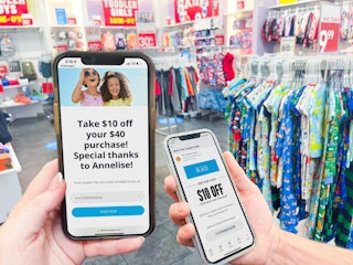 two people holding cellphones in store with email coupons