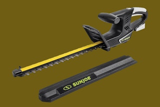 a sun joe hedge trimmer on a green background