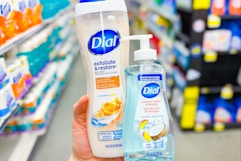 hand holding dial body wash and hand soap