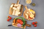 Classic Cuisine 3-Piece Acacia Wood Cutting Board Set used to cut different foods (lifestyle image)