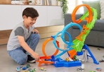 child playing with a Hot Wheels track