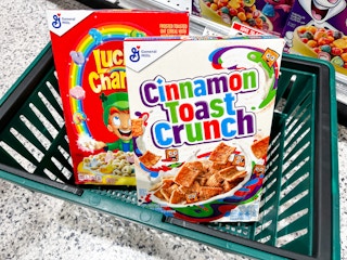 Shopping basket with two cereal boxes in it.