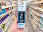 hand holding hask hair oil in walgreens