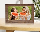 a wooden digital picture frame on a table 