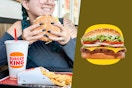a person eating a whopper at burger king
