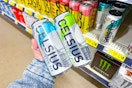 hand holding celsius energy drinks