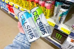 hand holding celsius energy drinks