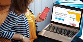 person booking travel on laptop and phone