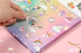 a hand opening up an advent calendar